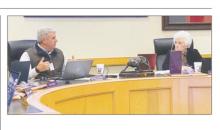 Jacksboro ISD Superintendent Brad Burnett gives his report as Martha Salmon listens during the Monday, Feb. 12 meeting.