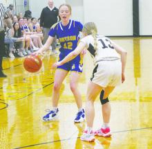 Braydee Thorne (12) dribbles downcourt during the Jan. 30 game with Woodson. Photo/Brian Smith