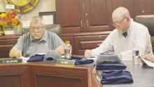Perrin-Whitt CISD Superintendent Cliff Gilmore, left, gives his monthly report on attendance, enrollment and other items as Board Vice President Mark Sims listens in. Photo/Brian Smith