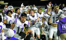 The Jacksboro Tigers celebrate after winning the regional semifinal champions title. The team moves forward after their 49-48 win Friday, Nov. 24 over the Holliday Eagles in overtime. Photo/Thomas Wallner