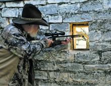 Larry Weishuhn takes aim inside an old stone outpost during a hunt last week in west Texas. Photo/Luke Clayton