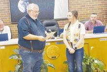 Jacksboro Mayor Craig Fenter reads a proclamation to Keelyn Merworth during a Jacksboro City Council meeting Monday, March 27. Merworth received a Girl Scout Gold Award for her work on a project. Photo/Brian Smith