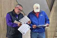 (BRIAN SMITH | JACKSBORO HERALD-GAZETTE) Jack County Judge Keith Umphress and Jacksboro City Manager Mike Smith look over early voting results at the Jack County Courthouse on election day. 