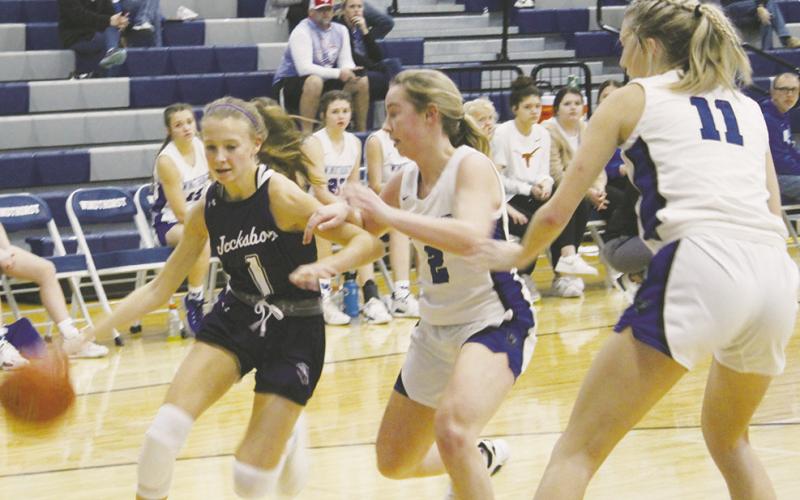 Jacksboro’s Brailyn Tullous (1) looks to get by the Windthorst defenders during first half action in their Tuesday, Nov. 29 game with the Trojanettes. The Tigerettes lost a 52-32 verdict. Photo/Brian Smith