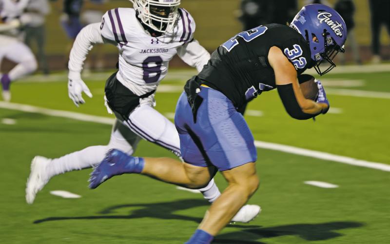 Jacksboro Tiger junior Kaleem Howard (8) looks to put the defensive hit on Gunter running back Ashton Bennett during the Thursday, Nov. 17 area round game in Grapevine. Jacksboro saw their season end at 8-4 with a 48-7 loss to the Tigers. Courtesy photo