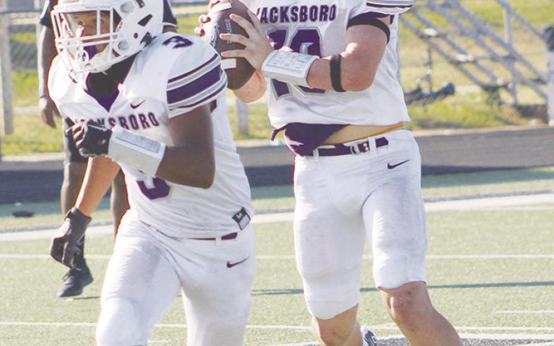 Jacksboro’s JV Purple quarterback Wyatt Gavit looks for an open receiver with Josh Salazar providing blocking. The Tigers remained perfect in district play with a win over Merkel. Photo/Brian Smith
