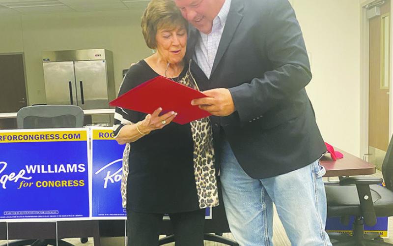 Jack County Judge Keith Umphress presents Carolyn Nichols a proclamation from State Senator Drew Springer’s office honoring her husband Joe Paul for his work in the country music industry. The presentation was made during Congressman Roger Williams’ town hall meet Oct. 11 at the Faith Community Hospital Board Room. Nichols was also a county commissioner. Photo/Brian Smith