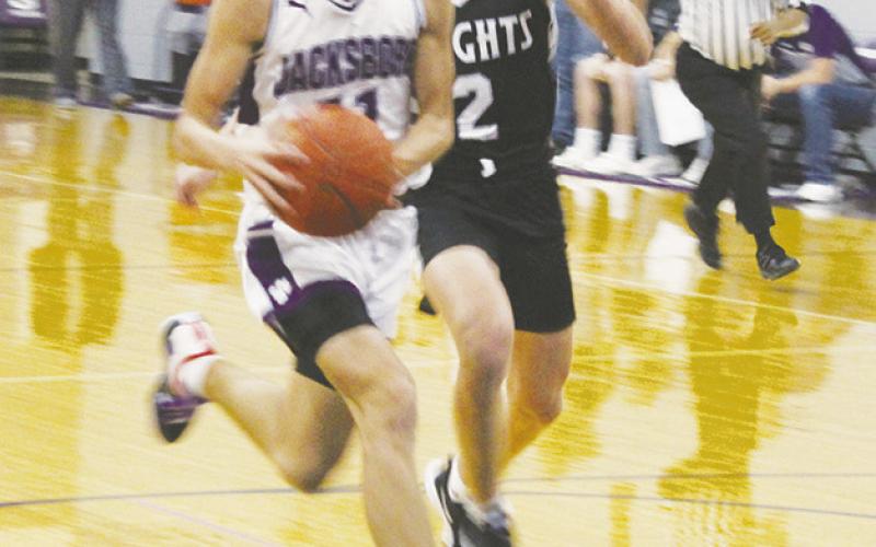 Kasey Ray Swan (11) heads to the basket with a Lindsay defender on his heels. Swan led the team in scoring as Jacksboro beat the Knights Friday night at home. Photo/Brian Smith