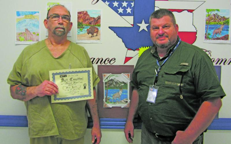 Warden Brian Collins, right, is seen with inmate Fred Lewis, one of the art contest winners. Courtesy photo
