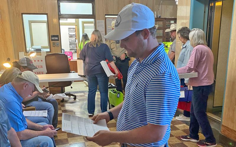 (Photo/Brian Smith) Tyler Harmonson looks over unofficial election results. Harmonson won the Place 5 alderman position.