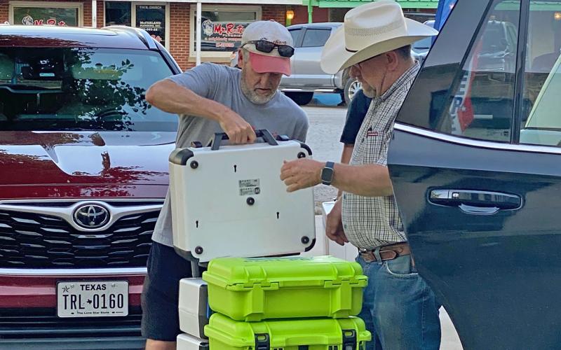 (Photo/Brian Smith) Sheriff T-Bob Hauger helps load a cart with election results. The Jack County Sheriff’s Department assists during every election. 