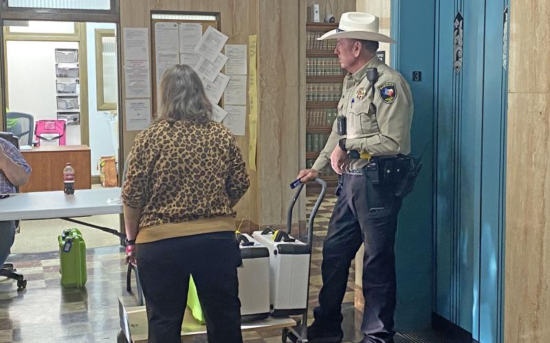 (Photo/Brian Smith)  Election workers and a sheriff’s deputy wait for the election results.