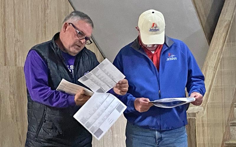 (BRIAN SMITH | JACKSBORO HERALD-GAZETTE) Jack County Judge Keith Umphress and Jacksboro City Manager Mike Smith look over early voting results at the Jack County Courthouse on election day. 