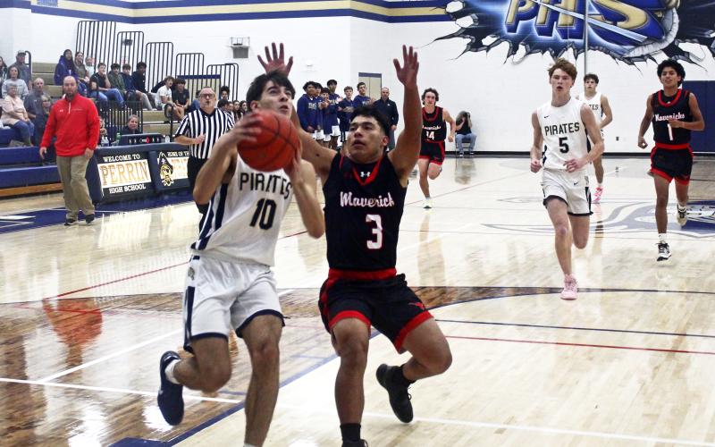 Jack McCormick looks to work his way around the Eastland defender. McCormick had a game-high 34 points in the Pirates’ win Tuesday, Nov. 12 over the Mavericks. Photo/Brian Smith