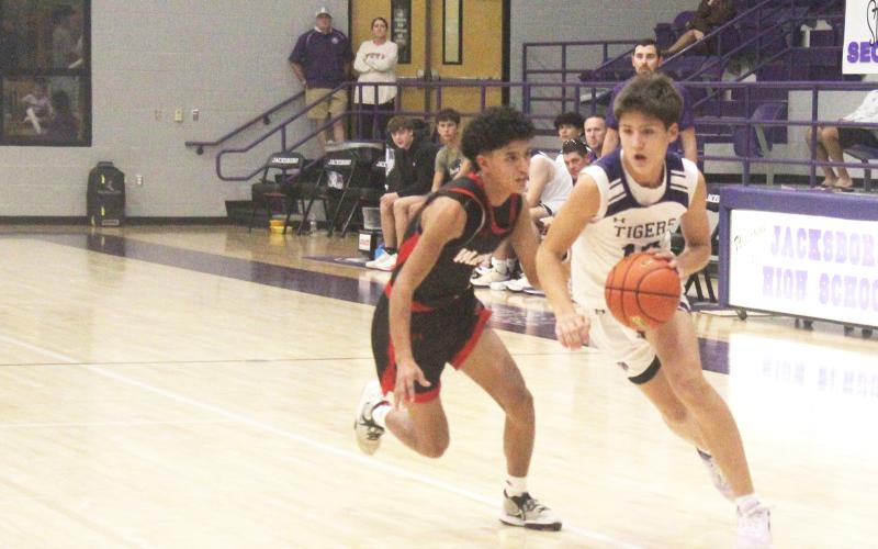 Jacksboro junior Brayden Rockey dribbles to get into the lane. Rockey had 8 points, including two 3-pointers, in the Tigers’ 65-17 win over Eastland. Photo/Brian Smith