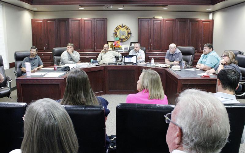 Perrin-Whitt School Board members call for a bond election in November. From left are board members Michael Francis, Michael Adams, President Chris Keeney, Superintendent Loren Sell, Vice President Mark Sims, Chad Lambert and Delaina Henderson. Attending remotely through video conference is James Hall. Photo/Ashley Anderson