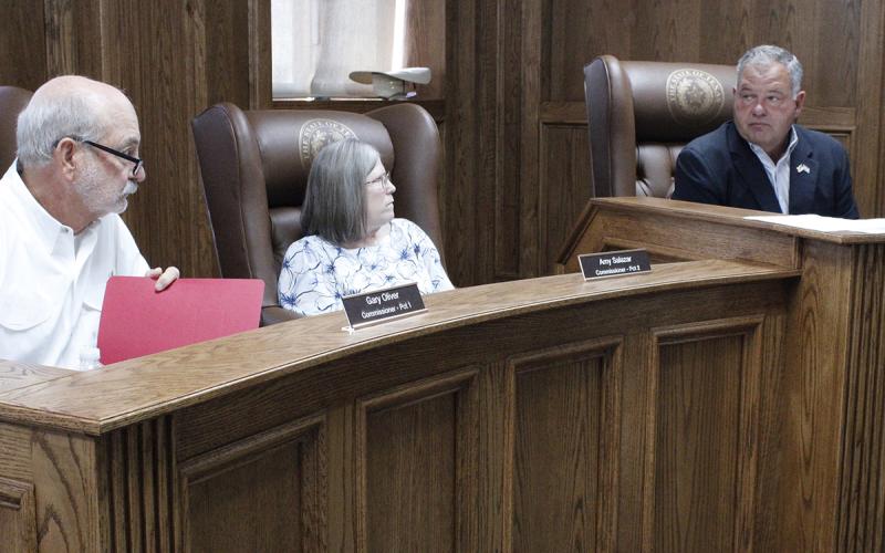 Jack County commissioners talk about last minute budget changes before approving the budget and tax rate for fiscal year 2025-2026. Pictured from left is Commissioner Gary Oliver, Commissioner Amy Salazar and Jack County Judge Keith Umphress. Photo/Ashley Anderson