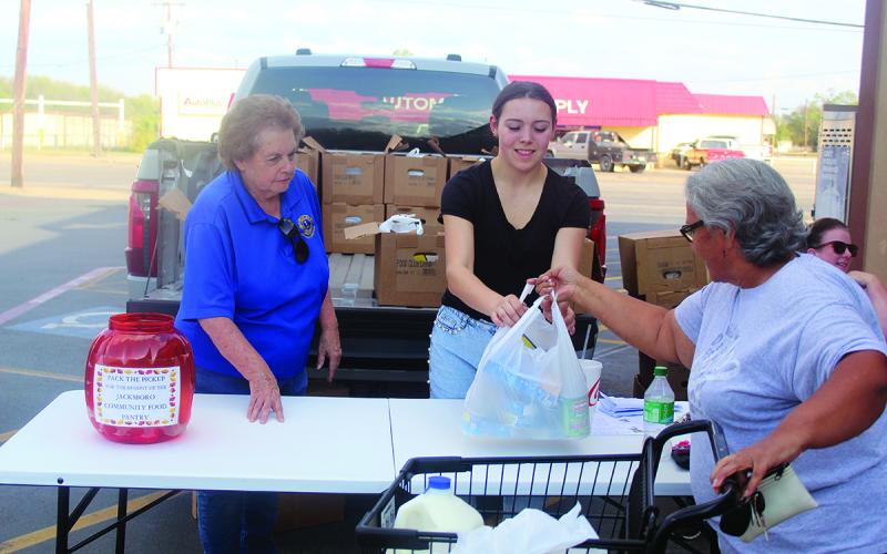 Jacksboro Lions Club members Donna Cassle and Madison Collins collect donations for Pack the Pickup in 2024 in front of Lowe’s Market. The annual donation event, taking place from 3-6 p.m. Wednesday, Oct. 29 through Friday, Oct. 31, will directly benefit the Jacksboro Community Food Bank’s monthly distributions. Archive photo