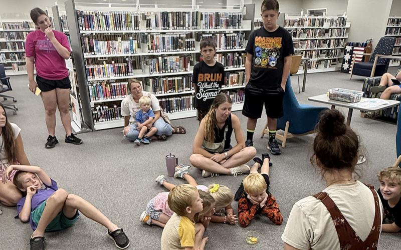 Kids gather 4-H sponsor Bailey Clack as she talks about hatching chicks. Jack County 4-H is partnering with the Gladys Johnson Ritchie Public Library to host the summer reading program throughout June. Contributed photo