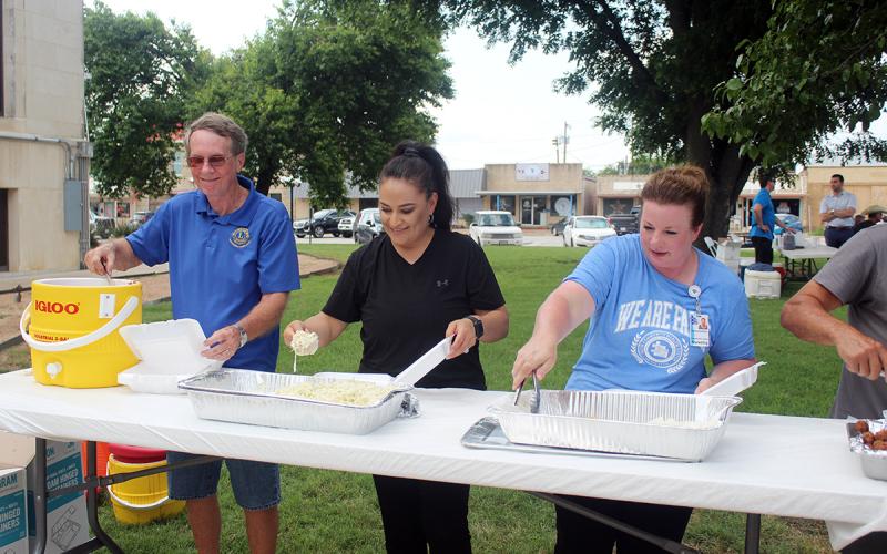 Tim Cassle, Nuvia Salazar and Melanie Belcher serve up the sides during last year’s annual Jacksboro Lions Club fish fry fundraiser. This year’s event is set for Thursday, June 4 on the east side of the Jack County Courthouse. Archive photo
