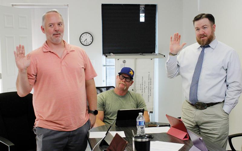 Bryson City Council members JR Stearns and Jesse Laine reaffirm their oaths of office Monday, May 11. The city canceled its local election after incumbents ran unopposed. Photo/Ashley Anderson