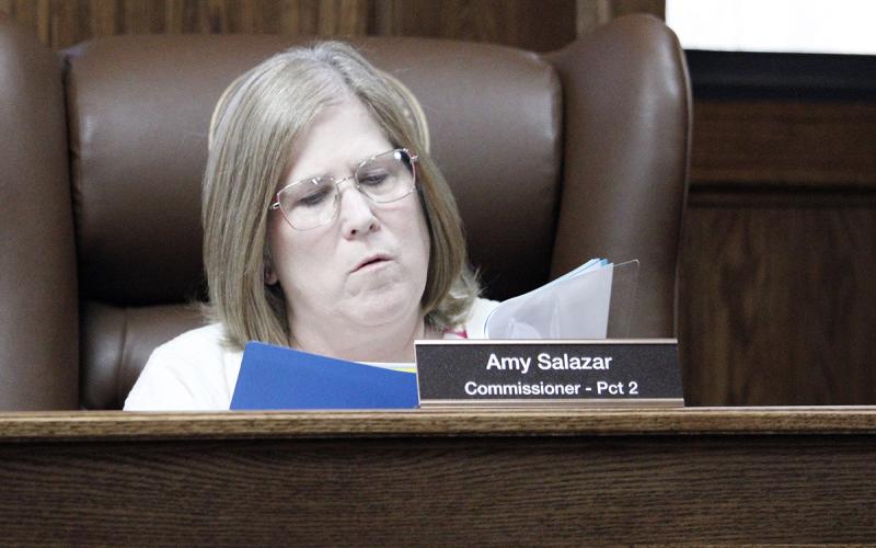Jack County Precinct 2 Commissioner Amy Salazar looks over images depicting the state of the Jack County Appraisal District building in Jacksboro. Commissioners voted Monday, March 23 in favor of the JCAD’s proposal to finance the purchase of a new building. Photo/Ashley Anderson