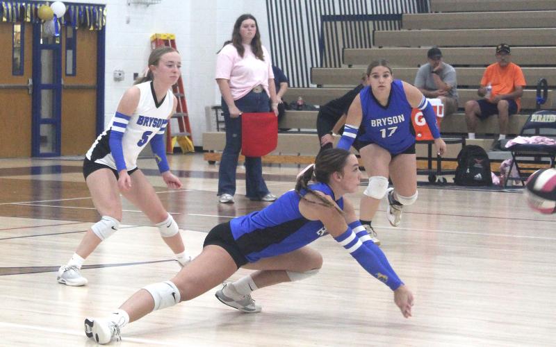 Cowgirl sophomore Jaydah McComack digs a ball out while teammates Braydee Thorne (5) and Johanna Herpeche (17) come in to help during the Cowgirls district opening loss in Perrin. (Photo/Brian Smith)