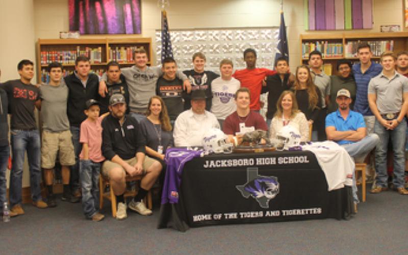 Cody Gary is surrounded by family and friends during his signing ceremony Monday.