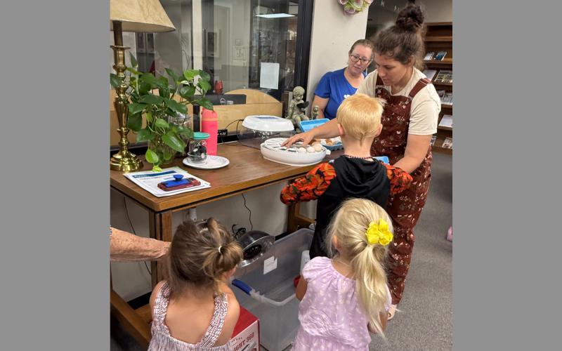 Kids gather 4-H sponsor Bailey Clack as she talks about hatching chicks. Jack County 4-H is partnering with the Gladys Johnson Ritchie Public Library to host the summer reading program throughout June. Contributed photo