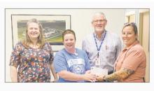 Lindsey State Jail officials made a donation check to Jacksboro Lions Club President Melanie Belcher, second from left, for their annual Pack the Bus drive for school supplies. Sandy Peevey, Grady Wallace and Amanda Davila presented the check.