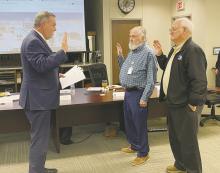 Faith Community Hospital Board Members Rod Hammond, and Larry Hopwood are sworn in to their unopposed positions by board attorney David Spiller during the Monday, Nov. 20 board meeting. Photo/Brian Smith