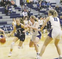 Jacksboro’s Brailyn Tullous (1) looks to get by the Windthorst defenders during first half action in their Tuesday, Nov. 29 game with the Trojanettes. The Tigerettes lost a 52-32 verdict. Photo/Brian Smith
