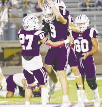Wyatt Gavit (9) celebrates a first half interception with teammate Hunter Moffit (27). Gavit also had a touchdown run late in the game as the Tigers remained perfect for the season and in district with a 78-13 victory Friday, Oct. 20 over Merkel. Photo/Brian Smith