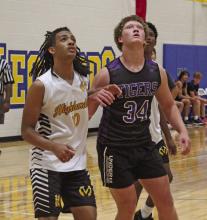 Will Treadway looks to get rebounding position on the Lawton McArthur player during the Tigers 74-35 win Tuesday, June 18. Photo/Brian Smith
