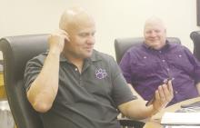 Jacksboro ISD board member Chris Payson tries on a pair of earbuds which allow languages to be translated in real time. Photo/Brian Smith