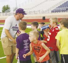 Jacksboro Coach John Bennett works with youth during last year’s football camp. Basketball and baseball camps are scheduled for this upcoming week. File photo