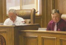 County Judge Keith Umphress, left, and Precinct 3 Commissioner Henry Birdwell look over the bills as part of the Monday, March 10 commissioners court meeting. Photo/Brian Smith