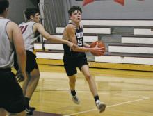 Kolby Burke (15) drives into the lane with Millsap defenders closing in. Burke had 14 points, including a pair of three pointers in the second half to help the Pirates defeat the Bulldogs 65-31. Photo/Brian Smith