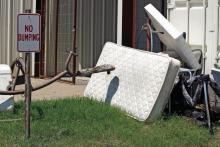 Old mattresses and playground equipment are tossed out at the Jack County Clothes Closet, even though signs state no illegal dumping, broken furniture or trash. Photo/Ashley Anderson