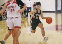 Perrin’s Jack McCormick skirts past some defenders during the Pirates’ 78-53 win Thursday, Dec. 7 over Sweetwater during the Red, White and Blue Tournament in Graham. McCormick was named to the All-Tournament Team along with five other athletes. Photo/T.C. Gordon