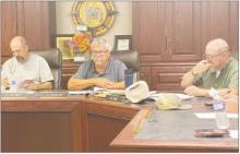 Perrin-Whitt CISD Superintendent Cliff Gilmore, center, gives his monthly report while Chris Keeney, left, and Mark Sims listen in during the board’s meeting Tuesday, Sept. 19. Photo/Brian Smith