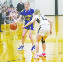 Braydee Thorne (12) dribbles downcourt during the Jan. 30 game with Woodson. Photo/Brian Smith