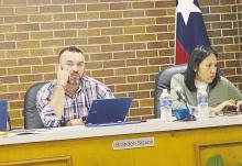 Place 2 Alderman Brandon Sisson listens to a response on the tornado abatement proposal during a Jacksboro council meeting Monday, Oct. 24, while Place 1 Alderman Libby Gonzales does some research. Photo/Brian Smith