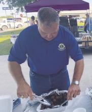 Lions Club members work on getting plates assembled for hungry customers. Nearly all active Lions Club members are involved in some way during the fish fry. Archive photo