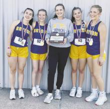 Above, Bryson Cowgirls athletes Hanna Perez, Tracy Hauger, Coach Emily Chenault, Loralai Lee and Allie Orr pose with their regional trophy. The quartet will represent Bryson High School at this year’s state track meet. Their race is set for 5 p.m. Saturday, May 13 at Mike A. Myers Stadium, located at 707 Clyde Littlefield Dr, in Austin. Courtesy photo