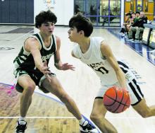 Perrin’s Jack McCormick (10) looks to drive the baseline but the Breckenridge defender has other ideas. The Pirates came back from 12 points down in the fourth quarter and seven points behind in the first overtime, but wound up losing 77-74. Photo/Brian Smith