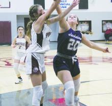 Jacksboro senior Avery Bennett (20) attempts to block a Poolville shot during first half action Tuesday, Dec. 6 against the Lady Monarchs. Photo/Brian Smith
