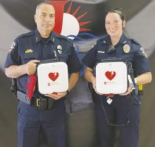 Jacksboro Police Chief Bryan Corb and Officer Erin McGuire show some of the new automatic defibrillators received by the department last week. Each patrol unit will receive one of the AEDs through a grant from Firehouse Subs. Photo/Brian Smith