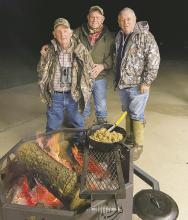The writer, center, is cooking with friends Edgar and David Cotton during a recent hunt. Photo/Luke Clayton