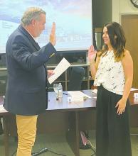 New Jack County Hospital District board member Heather Sisson is sworn in by board attorney David Spiller during the Thursday, Aug. 15 meeting. She replaces Rod Hammond. Photo/Brian Smith